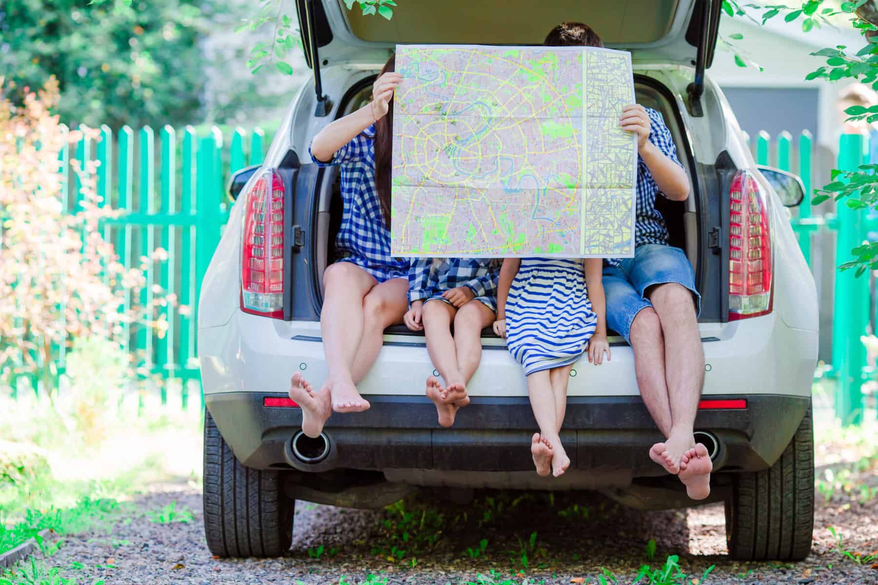 A roadschooling family examining a map while traveling