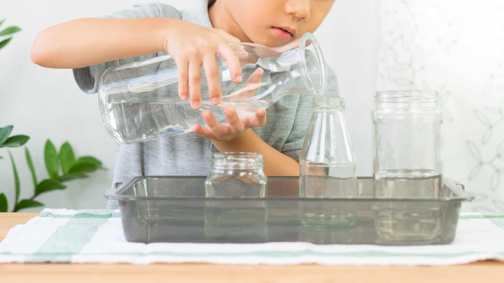 A child exploring the concept of conservation during their Montessori homeschooling activities