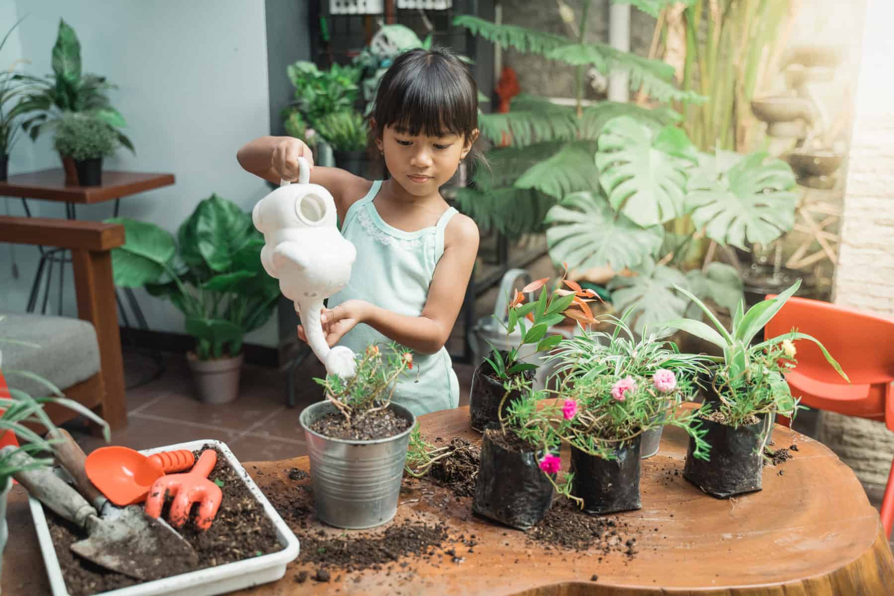A student tending a garden as part of their Montessori homeschooling lessons