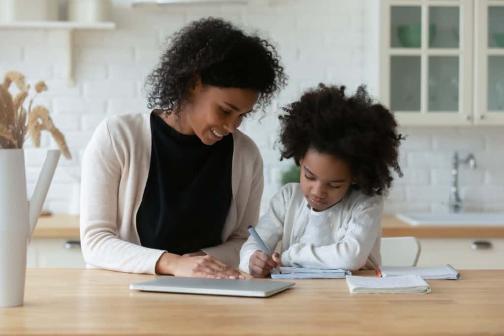 A student and child working on homeschooling in New York