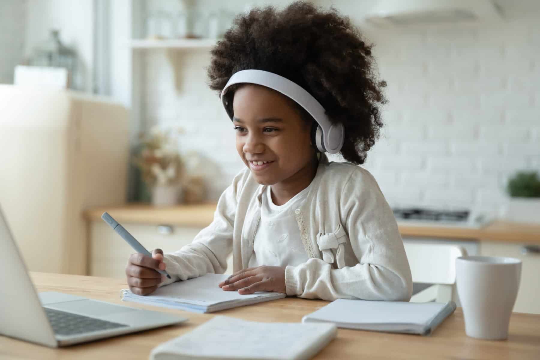 A young girl with autism homeschooling and learning at a desk