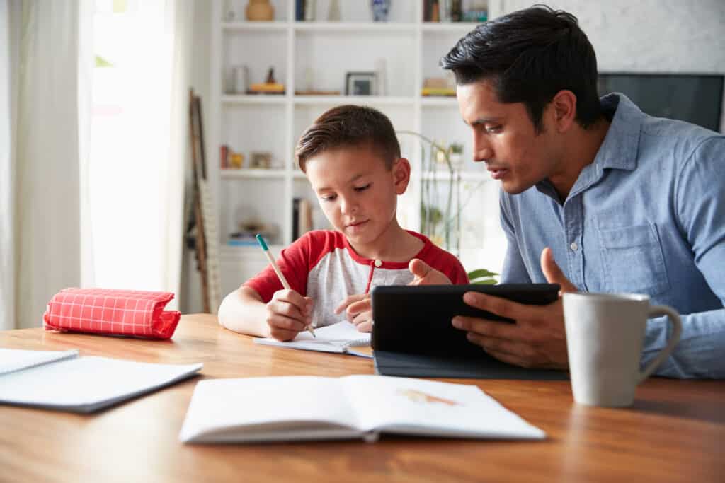 A young boy with autism homeschooling with his father