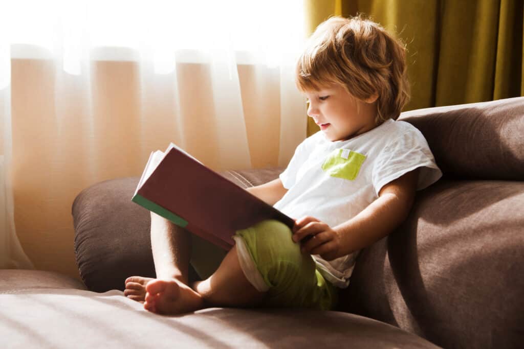 A child with a learning difference such as dyslexia reading while homeschooling