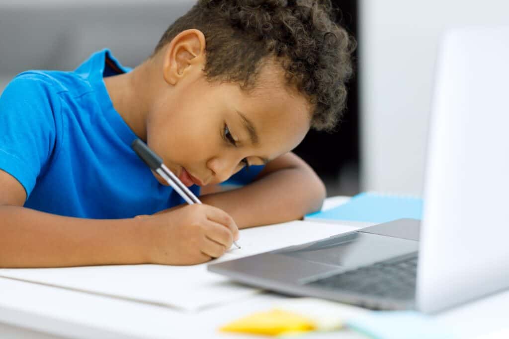 A homeschooled gifted child focusing on their schoolwork