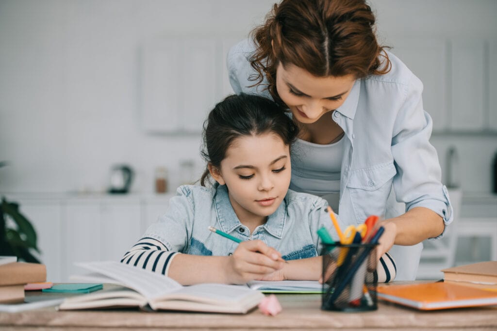 Mother helping her daughter with school work