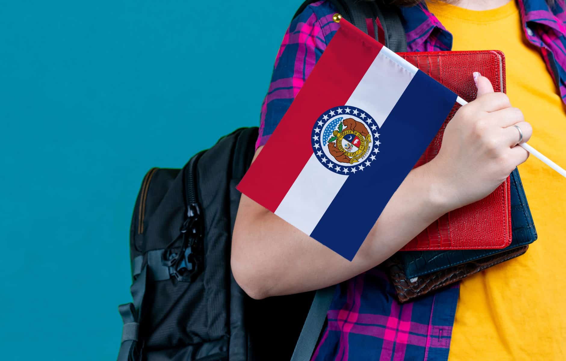 Student holding Missouri flag