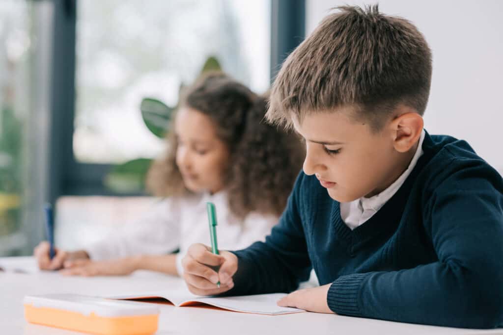 Small boy doing homework at a table