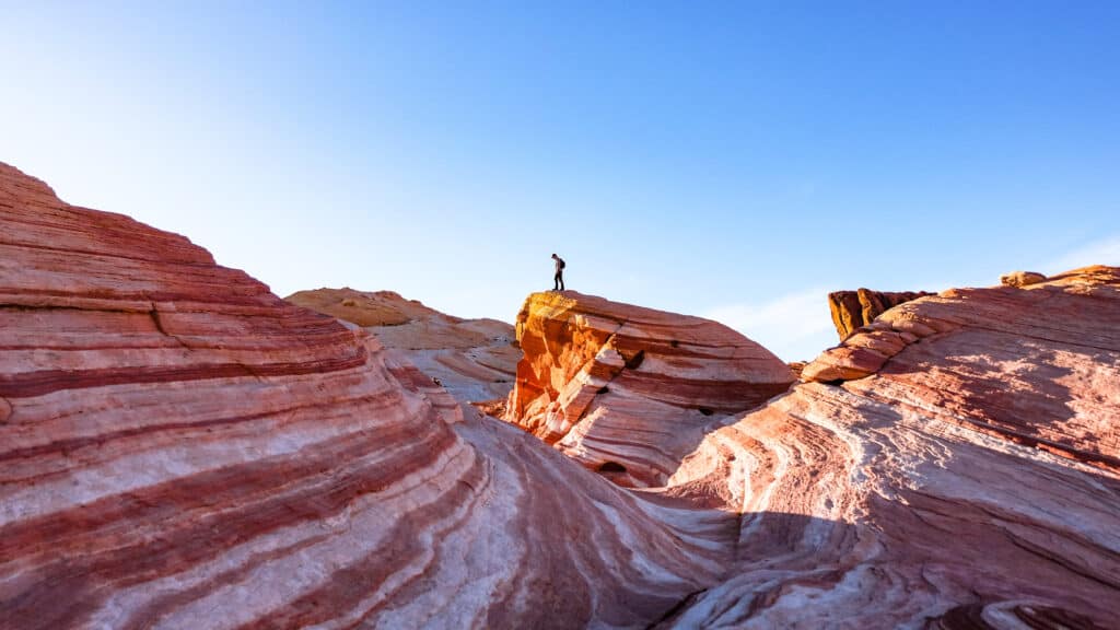 Image of a hiker on the Fire Wave in the Valley of Fire State Park in Nevada.