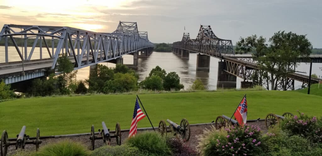 Image of two bridges crossing the Mississippi River at sunset