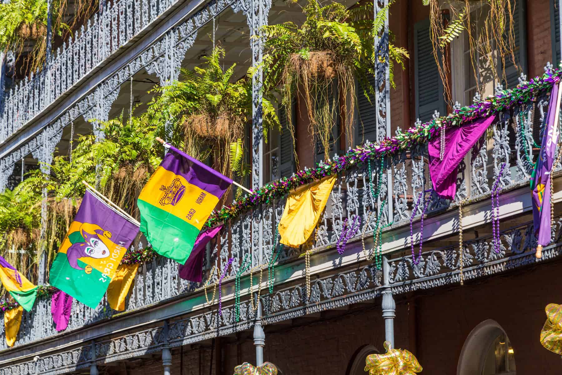 Ironwork fences in the French Quarter of Louisiana decorated for Mardi Gras
