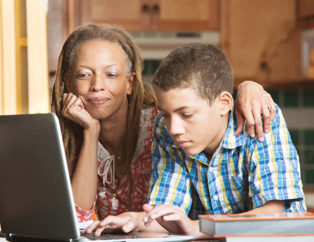 Image of mother helping her teenage son with his homework