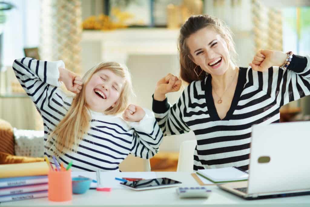 Image of a mother and her daughter smiling and having fun