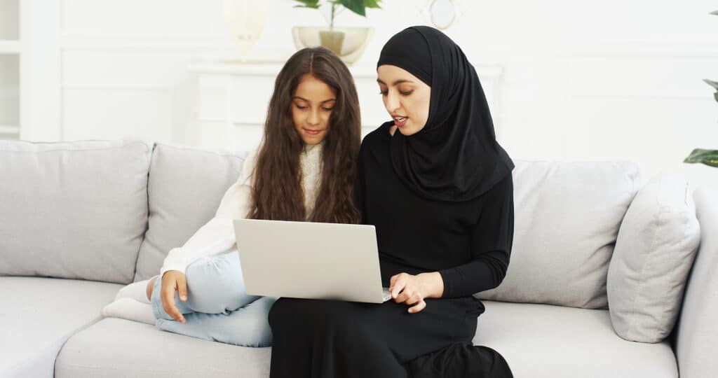 Mother and daughter using a laptop together