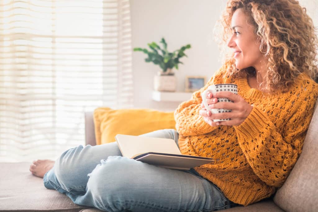 Woman relaxing on the couch with a warm drink