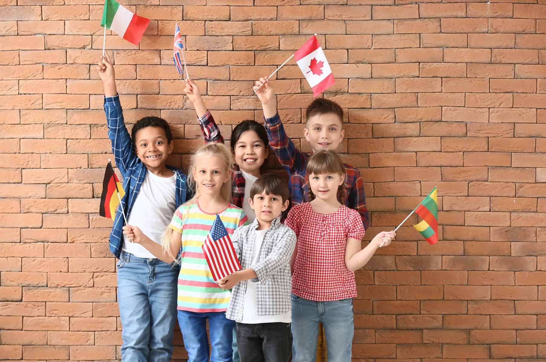 Kids holding up different country flags