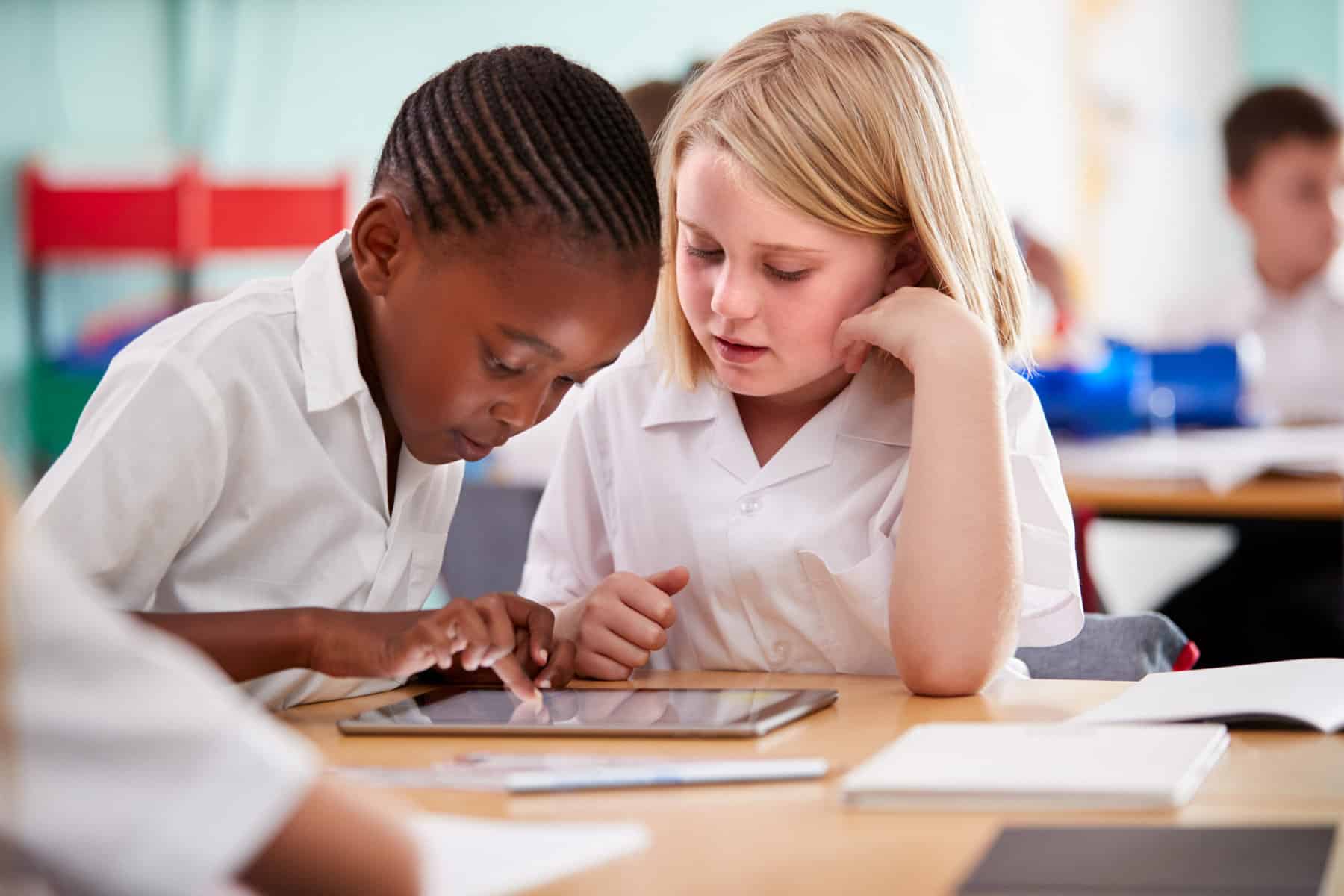 little girl and boy using a tablet together