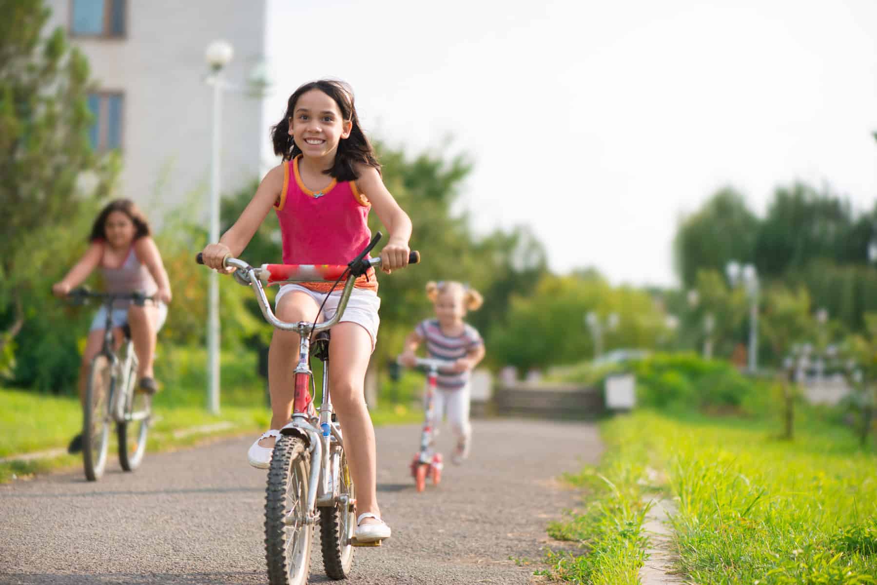 three kids riding their bikes